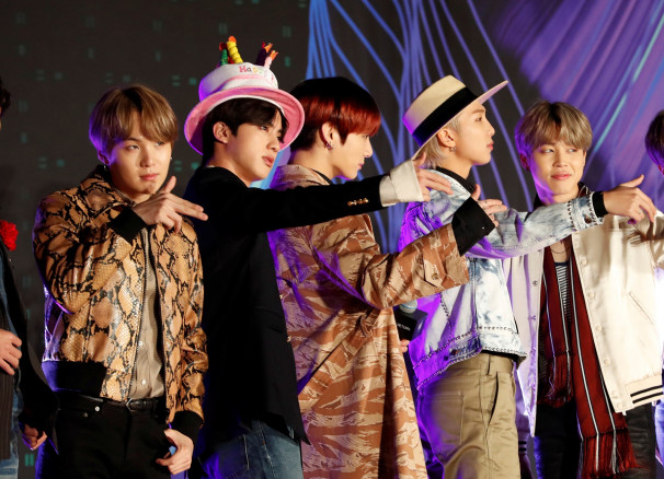 Suga, Jin, Jungkook, RM, Jimin, members of South Korean boy band BTS gestures to a camera on the red carpet during the annual MAMA Awards at Nagoya Dome in Nagoya