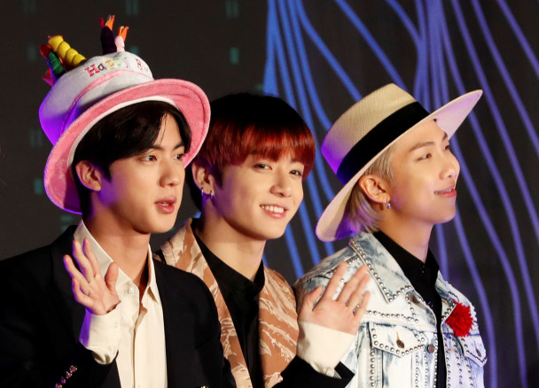 Jin, Jungkook, RM members of South Korean boy band BTS pose on the red carpet during the annual MAMA Awards at Nagoya Dome in Nagoya