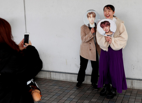Fans of South Korean boy band BTS take their photos before the annual MAMA Awards at Nagoya Dome in Nagoya