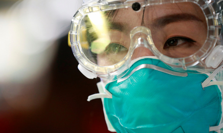 An official wears a protective mask and glasses at the arrivals hall of Suvarnabhumi Airport, as a measure to prevent the spread of coronavirus in Bangkok