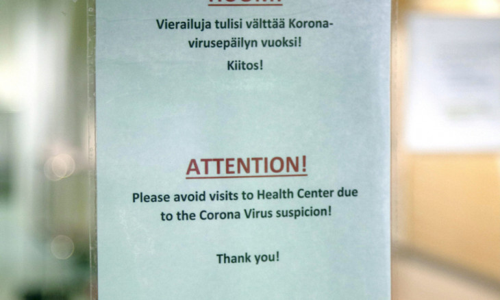 Advisory sign hangs on door of health centre in Ivalo