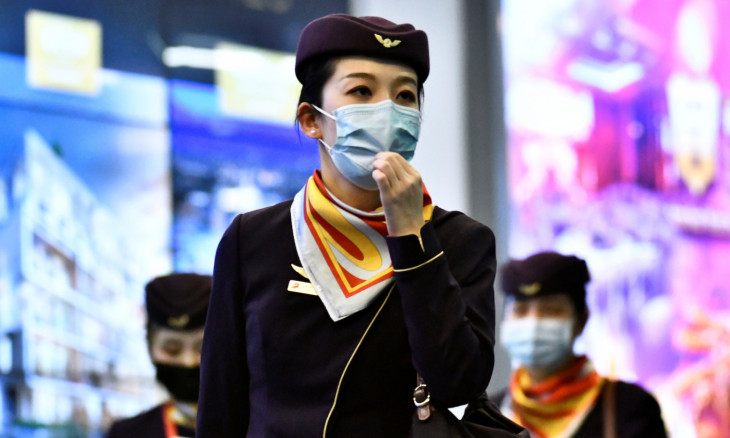 Flight crew wearing masks arrives on direct flight from China at Vancouver International Airport