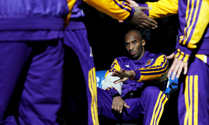 FILE PHOTO: Los Angeles Lakers Kobe Bryant reaches his hand out to teammates as the Lakers are announced before the start of the first half of their NBA basketball game against the Boston Celtics at TD Garden in Boston