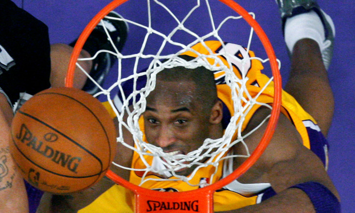 FILE PHOTO: Los Angeles Lakers Kobe Bryant eyes a rebound against the San Antonio Spurs during their NBA basketball game in Los Angeles