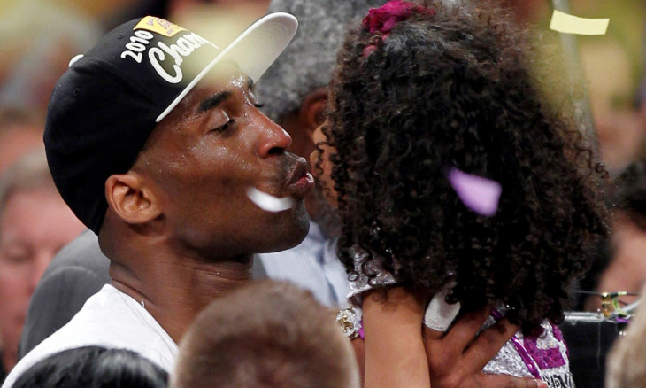 FILE PHOTO: Los Angeles Lakers' Bryant kisses his daughter after the Lakers defeated the Boston Celtics in Los Angeles
