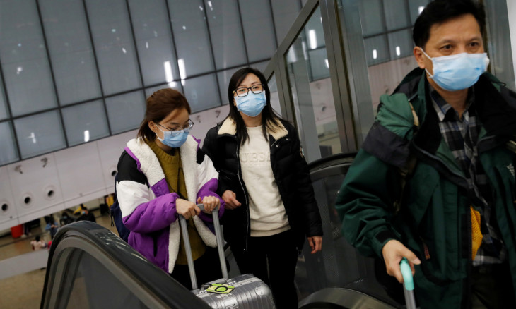 Passengers wear masks at Hong Kong West Kowloon High Speed Train Station Terminus, before temporary closing, following the coronavirus outbreak in Hong Kong