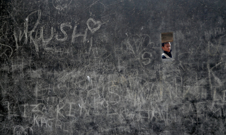 A man walks past a fort wall covered with graffiti on Valentine's Day in Mumbai