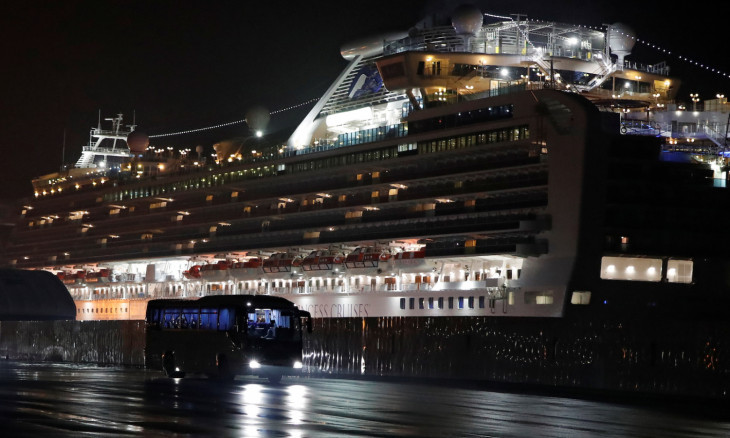 Buses believed to carry the U.S. passengers of the cruise ship Diamond Princess, where dozens of passengers were tested positive for coronavirus, leave at Daikoku Pier Cruise Terminal in Yokohama, south of Tokyo