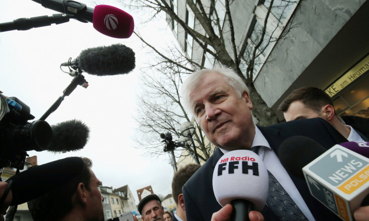 German Interior Minister Horst Seehofer speaks to the media at one of the crime scenes following a shooting in Hanau