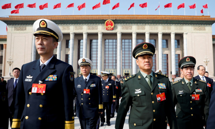 FILE PHOTO: Military delegates leave the Great Hall of the People after a meeting ahead of NPC in Beijing