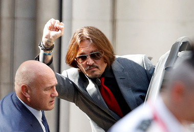 Actor Johnny Depp gestures as he leaves