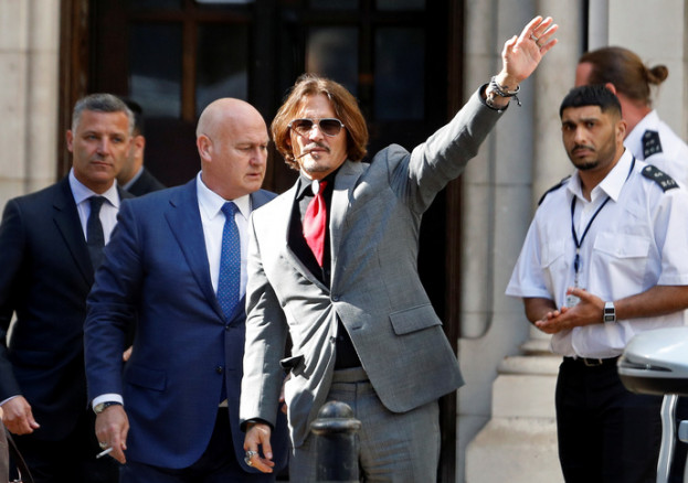 Actor Johnny Depp waves as he leaves the High Court