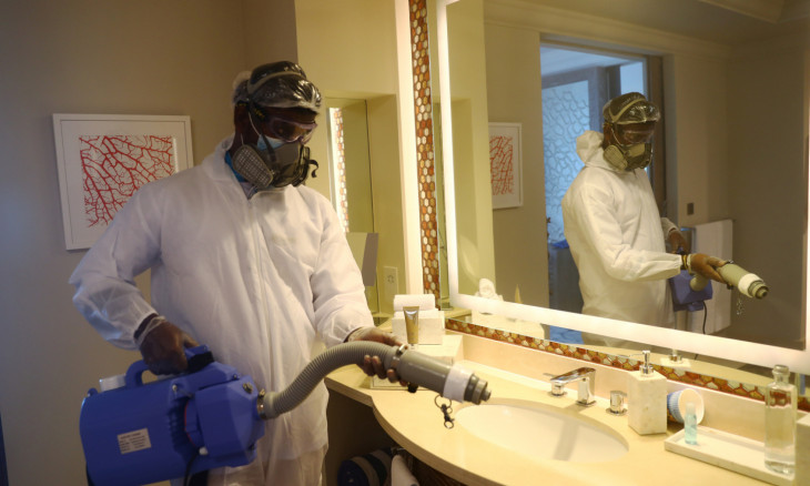 A worker wearing a protective suit sterilises a bathroom in the Atlantis The Palm hotel