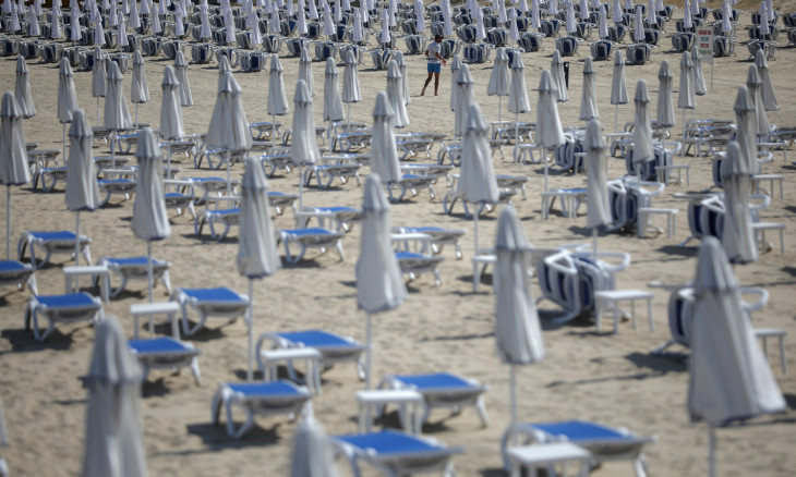A man walks near empty sunbeds at Sunny Beach resort