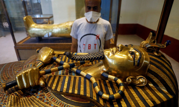 A tourist looks at the coffin of ancient pharaoh King Tutankhamen
