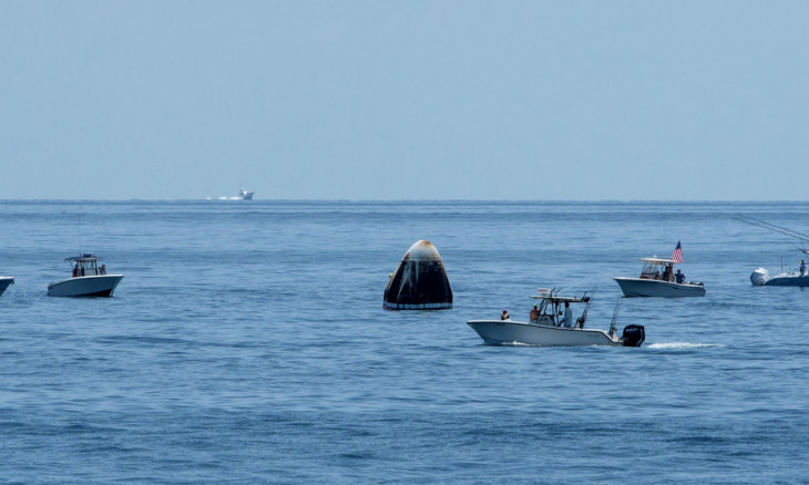 Support teams and curious recreational boaters arrive at the SpaceX Crew Dragon Endeavour spacecraft