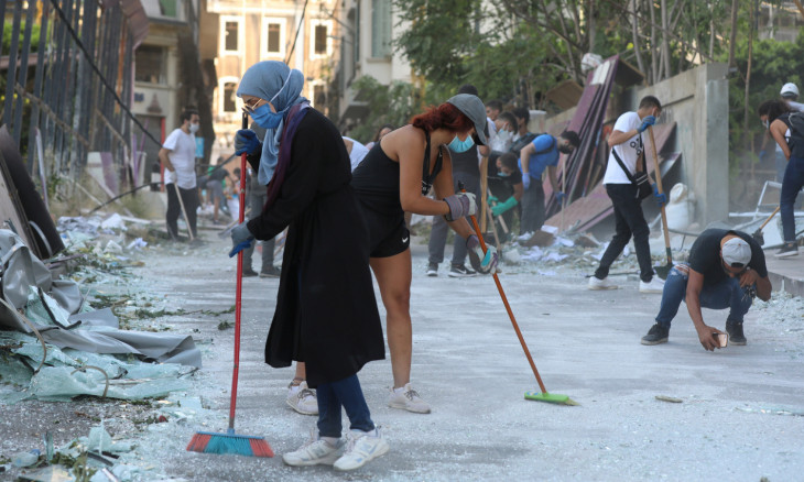 Volunteers clean the streets following