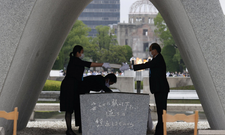 The name list of war dead is given to Hiroshima City mayor Kazumi Matsui from a representative of bereaved families