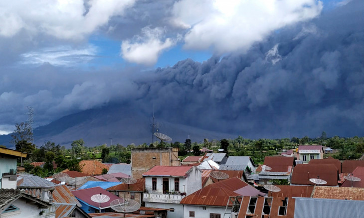 An ash cloud rises above Sinabung volcano 
