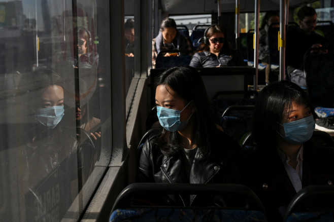 Lan Zhang and Elma Song travel on a bus as they go shopping in Sydney, Australia