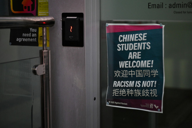 A sign reading "Chinese students are welcome! Racism is not!"