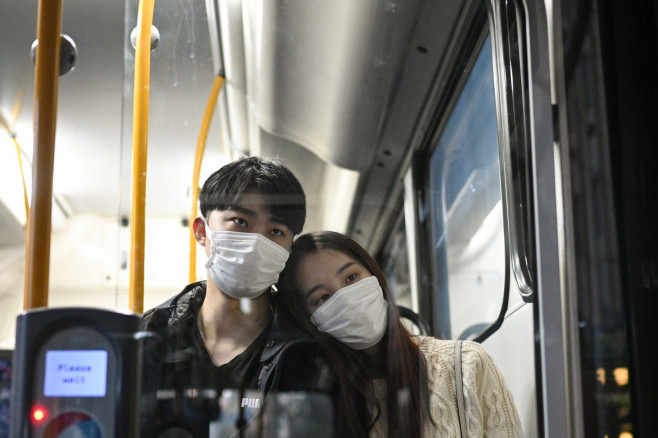 Sunny Gu and his girlfriend Maggie Zhang wear face masks as they ride a bus together