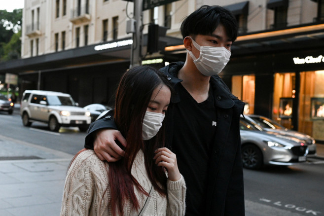 Maggie Zhang and her boyfriend Sunny Gu walk through the city centre