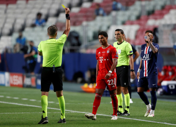  Bayern Munich's Serge Gnabry is shown a yellow card by referee Daniele Orsato