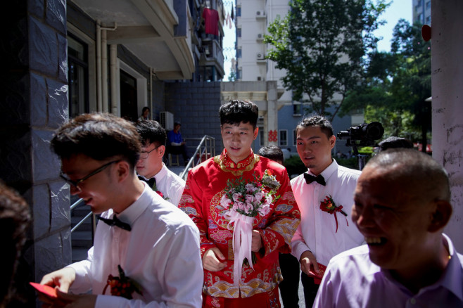 Wei Jiawen, 29, has her hair done on the day of her wedding to Pan Wenjun, 
