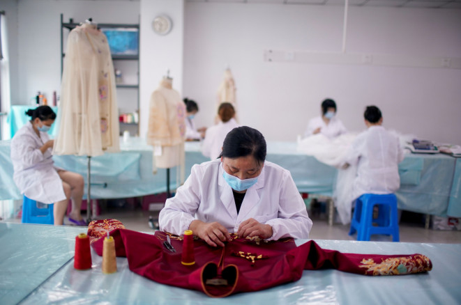 Employees from the export department of Suzhou Jusere Wedding & Evening Dress Co. Ltd work together