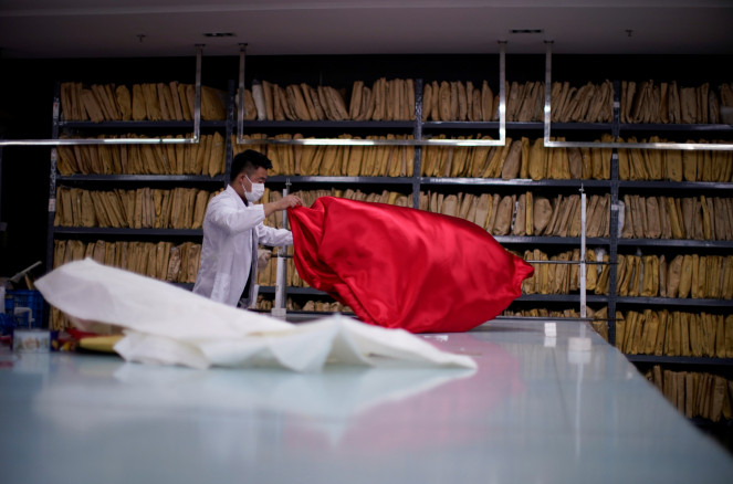 An employee works on a wedding dress at Suzhou Jusere Wedding & Evening Dress Co. Ltd's factory,