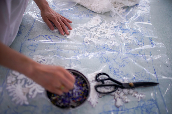 mployees work on garments at Suzhou Jusere Wedding & Evening Dress