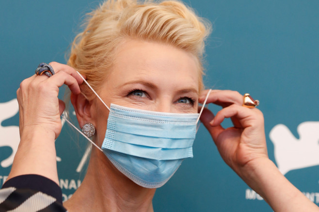 President of the jury Cate Blanchett adjusts her protective face mask. 