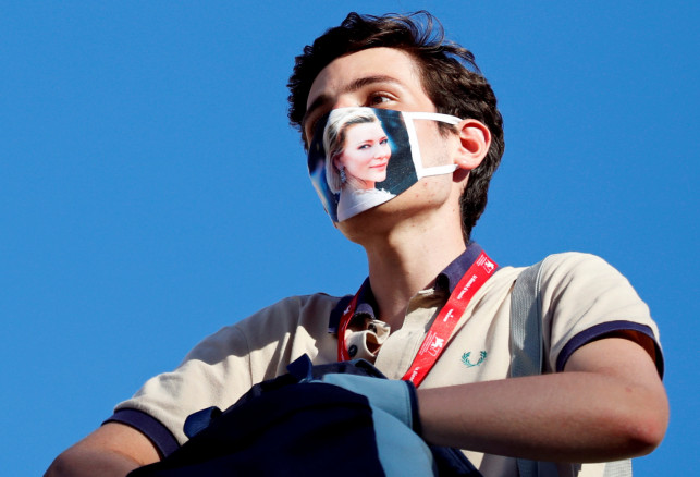 A fan wears a face mask depicting actor Cate Blanchett