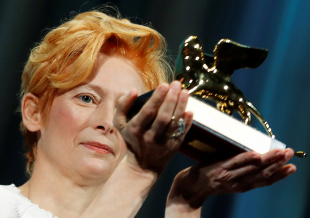 Actor Tilda Swinton poses with a Golden Lion award for lifetime achievement . 