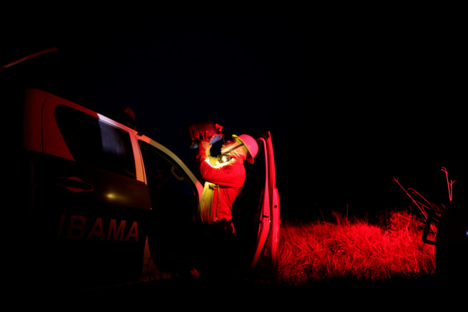A Brazilian Institute for the Environment and Renewable Natural Resources (IBAMA) fire brigade member drinks water