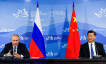 Russian President Putin and Chinese President Xi Jinping attend a meeting with participants of a round table discussion on Russia-China Cooperation