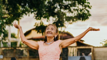 Woman raising her both hands.