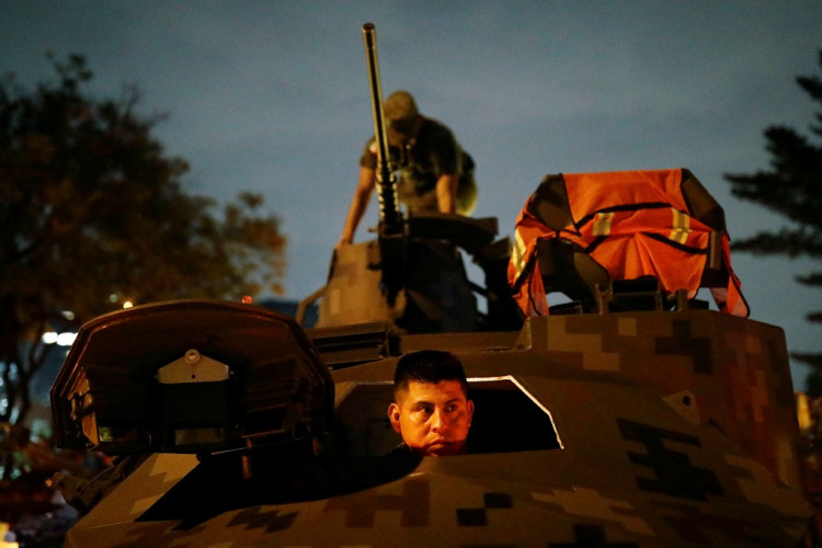 Soldiers prepare the weaponry over a war tank at the camp before attending a military parade at Independence Day celebration in Mexico City, Mexico September 16, 2019.