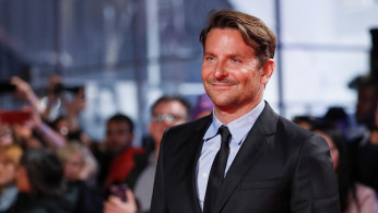 Bradley Cooper poses at the premiere of 