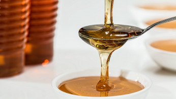 Honey on white bowl. 