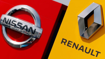 The logos of car manufacturers Renault and Nissan are seen in front of dealerships of the companies in Reims