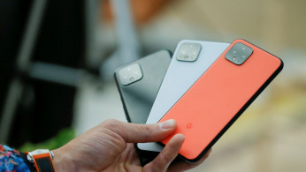 A man holds new Google Pixel 4 smartphones as they are displayed during a Google launch event New York