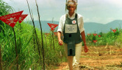 Diana, Princess of Wales walks in one of the safety corridors of the landmine field in Huambo, Angola