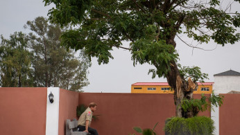 Britain's Prince Harry sits alone beneath the Diana Tree in Huambo