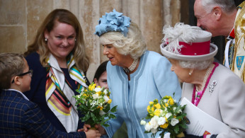 Britain's Camilla, Duchess of Cornwall, receives flowers as she and Queen Elizabeth leave after a visit at Westminster Abbey in London, Britain October 15, 2019. REUTERS/Hannah McKay
