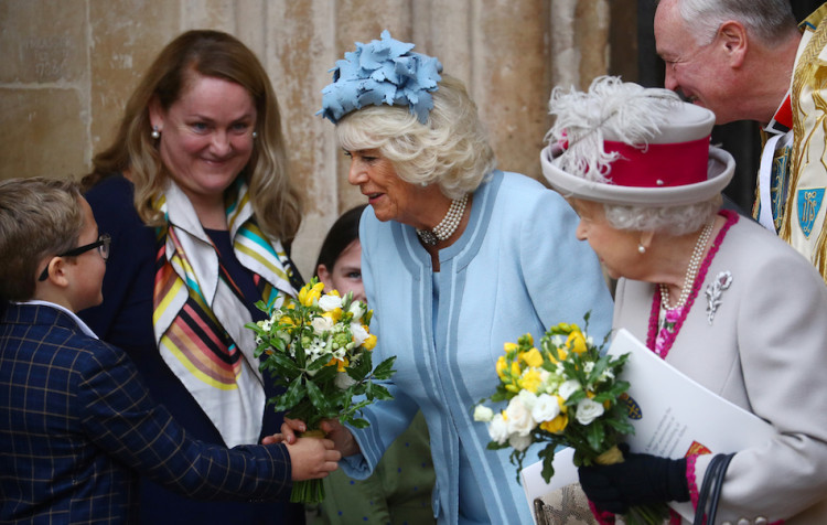 Britain's Camilla, Duchess of Cornwall, receives flowers as she and Queen Elizabeth leave after a visit at Westminster Abbey in London, Britain October 15, 2019. REUTERS/Hannah McKay