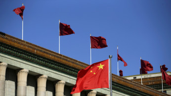 Chinese flag waves in front of the Great Hall of the People in Beijing