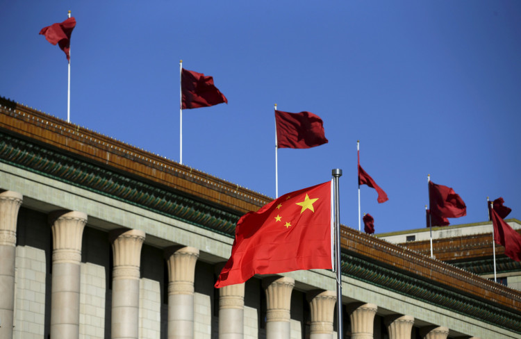 Chinese flag waves in front of the Great Hall of the People in Beijing