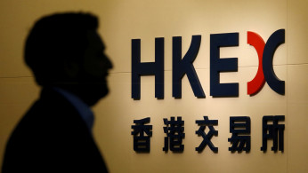 A man walks past the entrance to the Hong Kong Exchange in Hong Kong